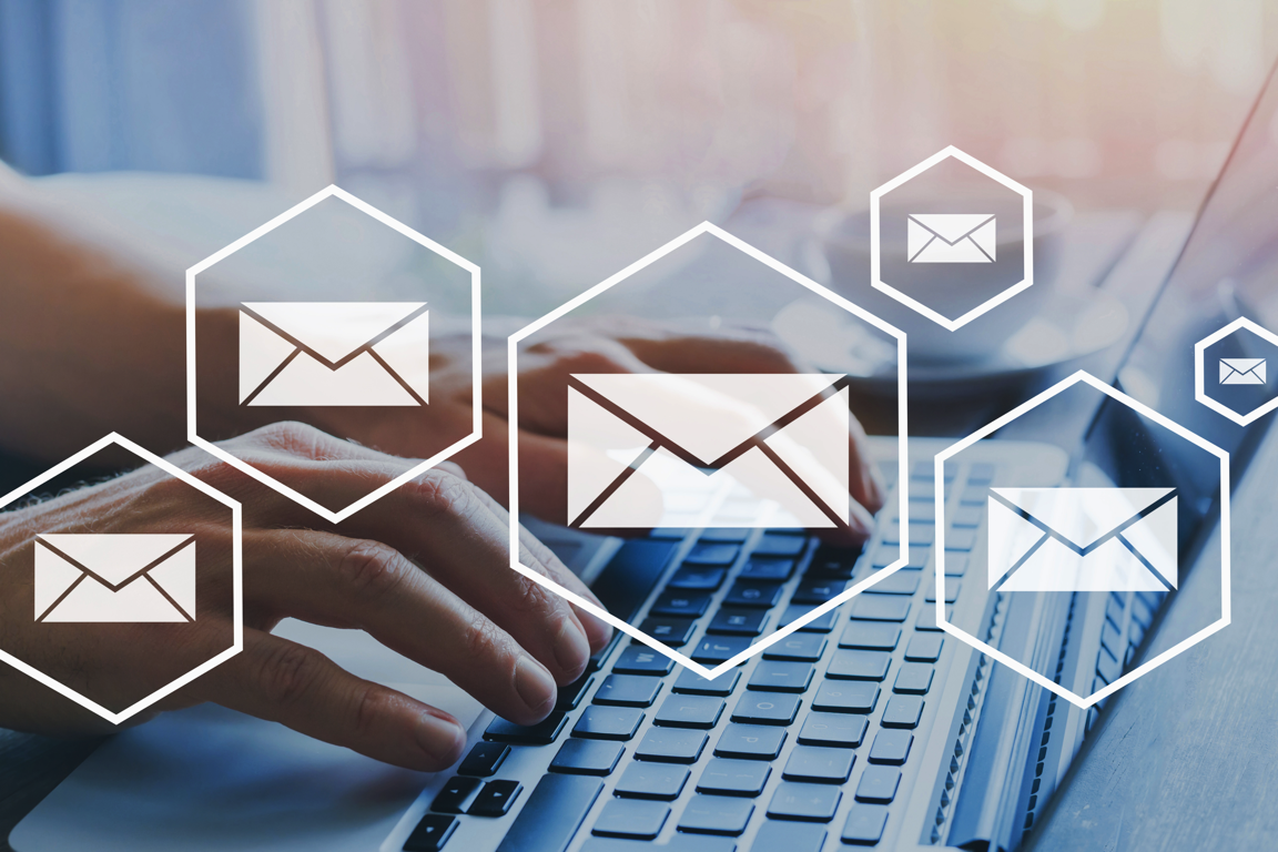 email icons-over laptop typing 